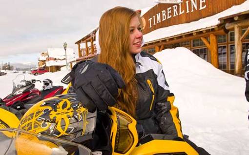 Teenage girl on snowmobile